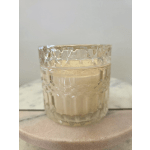 Clear textured glass candle holder with a pale cream candle inside
