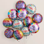 Cluster of colorful "Happy Birthday" balloons against a plain background