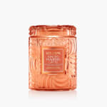Orange glass candle jar labeled Spiced Pumpkin Latte