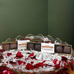 Chocolate boxes in a glass bowl with red heart decorations
