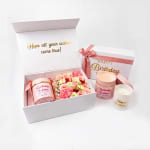Birthday gift boxes with pink flowers and candles
