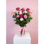 Pink and magenta roses with carnations in a glass vase tied with a pink ribbon