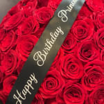 Red roses with a black "Happy Birthday Princess" ribbon