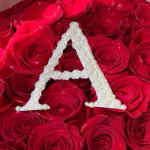 Red roses with a pearl letter A decoration