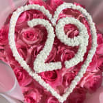 Pink roses arranged with white heart-shaped floral outlines