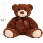 Brown teddy bear with a satin bow sitting on a white background