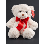 White teddy bear with a red ribbon bow on a dark background