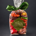 Bag of assorted chocolates wrapped in clear plastic with a green ribbon