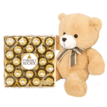 Teddy bear beside a box of Ferrero Rocher chocolates