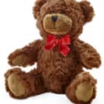 Brown teddy bear with a red bow on a white background