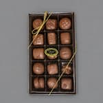 Box of assorted chocolates tied with a gold ribbon