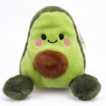 Plush avocado toy with a smiling face and brown pit