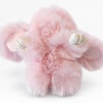 Pink plush teddy bear with white paws and gold accents