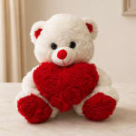 White teddy bear holding a red rose heart