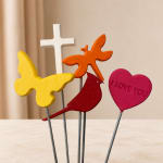 Decorative picks with a cross, butterfly, bird, and heart on sticks