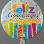 Round balloon with colorful candles and "feliz cumpleaños" text