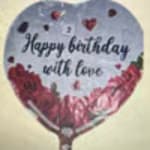 Heart-shaped birthday balloon with floral decoration and text