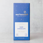 Blue box of Moonstruck dark chocolate on a light surface.