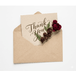 Thank you card in a kraft envelope with a red rose and pinecones