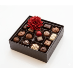 Box of assorted chocolates with a red flower decoration on top