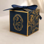 Navy and gold gift box with a large ribbon bow