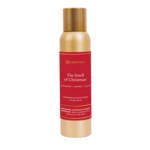 Gold and red spray bottle labeled The Smell of Christmas