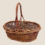 Empty woven wicker basket with a tall handle