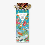 Chocolate bar in a floral printed wrapper with nuts and fruit pieces visible at the top