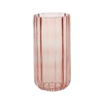 Pink ribbed glass vase on a white background
