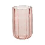 Pink ribbed glass vase on a white background