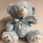 Light blue teddy bear with a satin ribbon