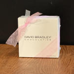 Box of David Bradley Chocolatier tied with a pink ribbon