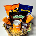Basket of assorted snack packs and a soda can arranged like a gift bouquet