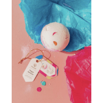 Birthday bath bomb with colorful tissue paper and gift tags