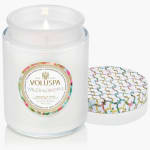 White scented candle in a glass jar with a patterned lid