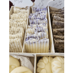 Assorted handmade soap bars in a divided display tray
