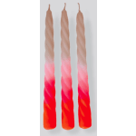 Three twisted taper candles in pink, red, and orange