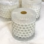 Three clear glass candle jars with geometric patterns and lids