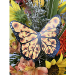 Butterfly decoration among bright sunflowers and orange flowers