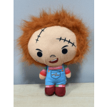 Plush doll with orange hair and stitched face wearing blue overalls