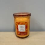Amber jar candle with a marigold label