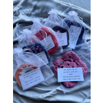Crocheted heart-shaped gifts in sheer organza bags with note cards