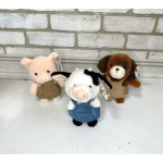 Three small plush animals standing on a white surface