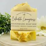 Yellow handmade soap bar with flowers and a label