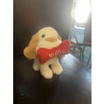 Plush dog holding a red bone toy with "xoxo" embroidery