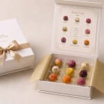 Gift box with colorful dried flower tea balls and a bloom guide card