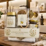 Wellness gift set with tea, dried lemon slices, and honey in a clear box.