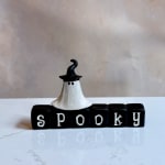 Halloween ghost figurine on blocks spelling spooky