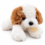 Plush brown and white puppy toy with a ribbon bow