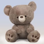 Plush teddy bear sitting against a plain background